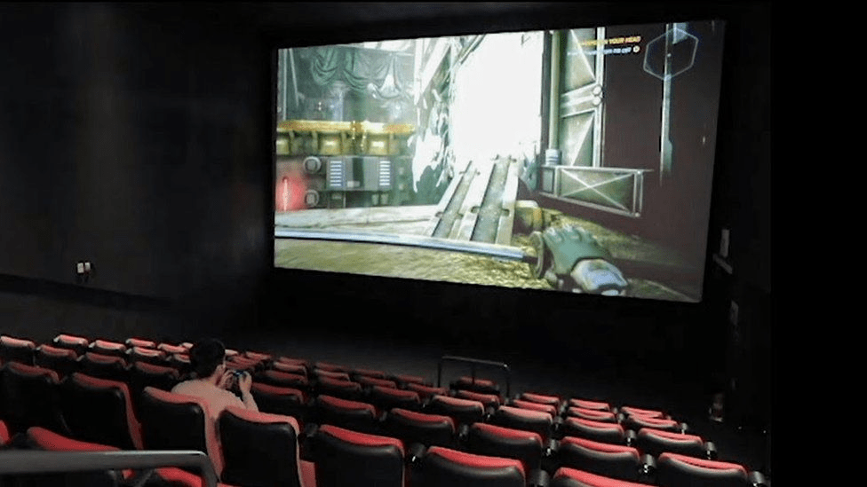 Gamers can enjoy playing video games on huge screens with high-definition audio.